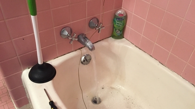 Image of Bathtub Won T Drain Standing Water How To Unclog A Bathtub Drain With Standing Water Using A Coat